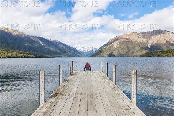 Woman sitting on dock