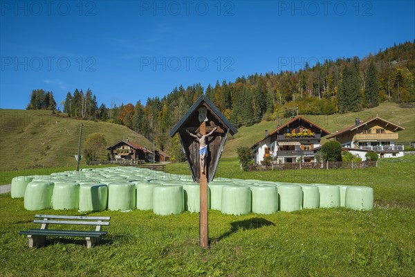 Silo bales in front of farmhouses