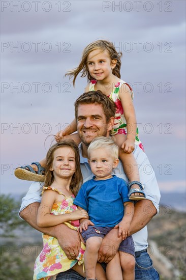 Father with three young children