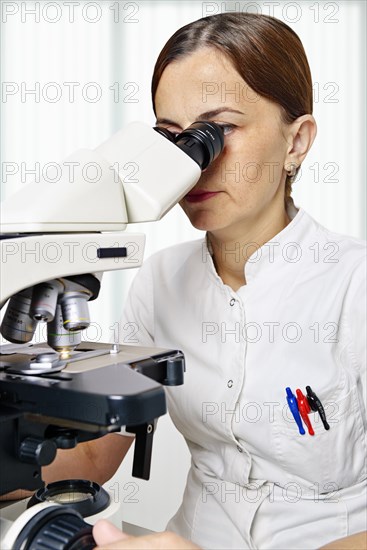 Pathologist using a microscope