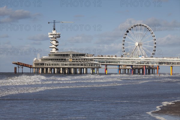 Pier with bungee jumping tower and Ferris wheel
