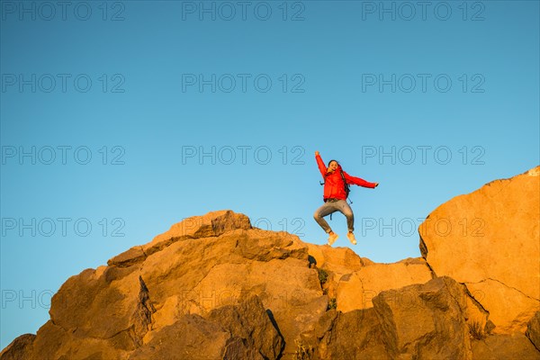 Young woman jumping in the air