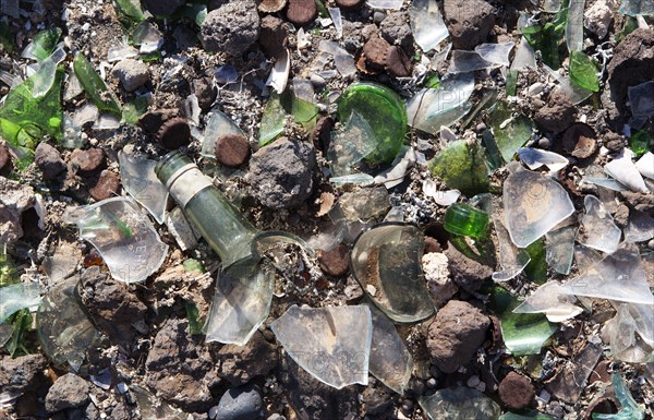 Broken glass and metal parts at a dump