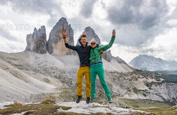 Two hikers make an air jump