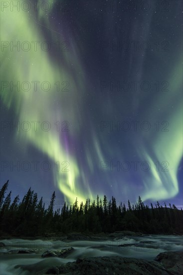 Northern Lights or Aurora Borealis above river Gamajahka or Kamajakka