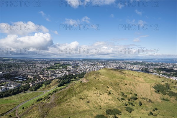 View across cliffs of Salisbury Crags into city of Edinburgh from Arthur's Seat