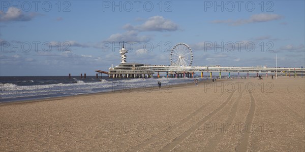 Pier with bungee jumping tower and Ferris wheel