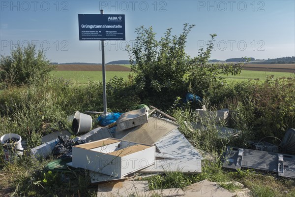 Illegal garbage dump at a green waste collection point in the countryside