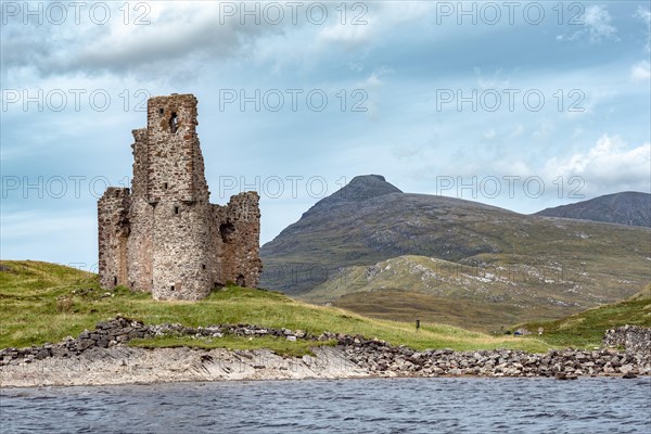 Castle ruin Ardvreck Castle on a peninsula by lake Loch Assynt