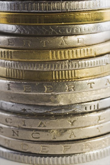 Stack of silver and gold international coins