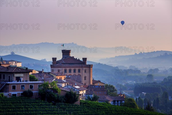 Hot-air balloon at sunrise over Barolo