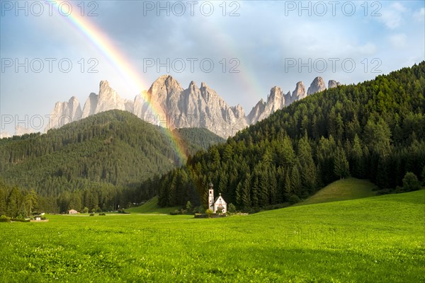 Rainbow in front of the church St. Johann in Ranui