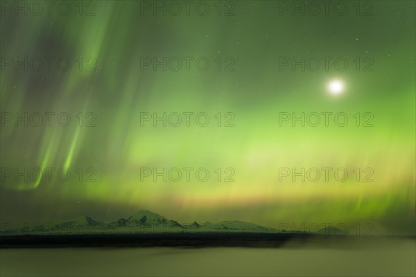 Aurora and the moon over the fog shrouded Copper River