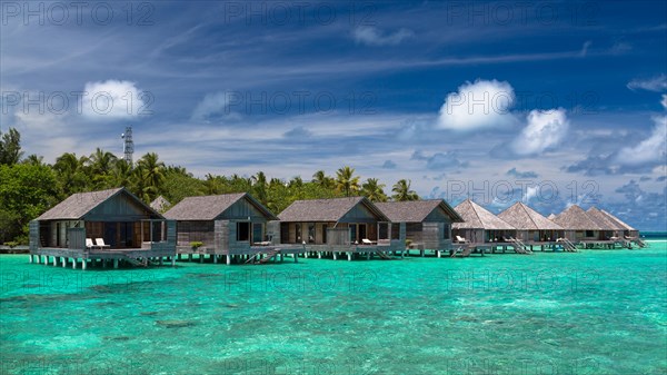 Wooden huts on stilts in lagoon