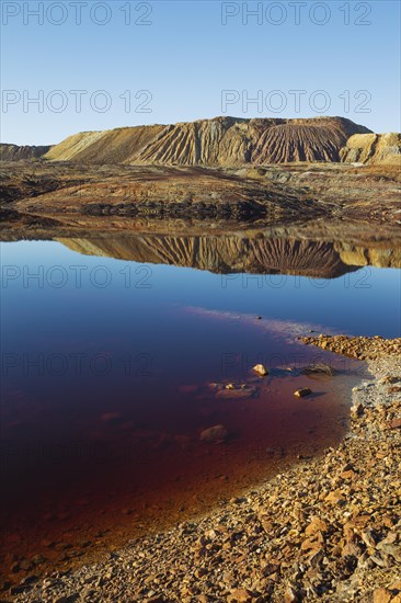 Mineral-rich ground and rocks with rainwater pool at Rio Tinto mines