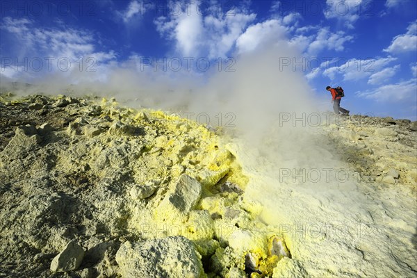 Hiker on the Gran Cratere walks through sulphur fumaroles