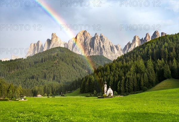 Rainbow in front of the church St. Johann in Ranui