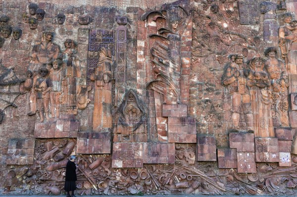 Close-up of faces from communist era on facade of city market