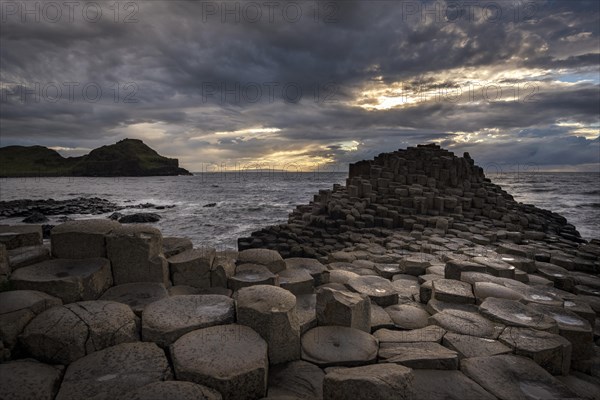 Basalt columns by the coast at sunset