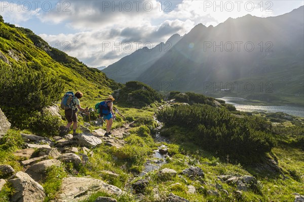 Two hikers on a trail in the morning