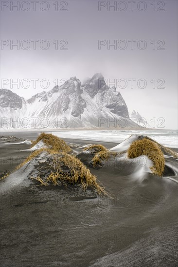 Black lava beach with fresh snow