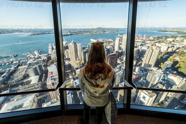 Tourist enjoying the view from the observation deck of the Sky Tower