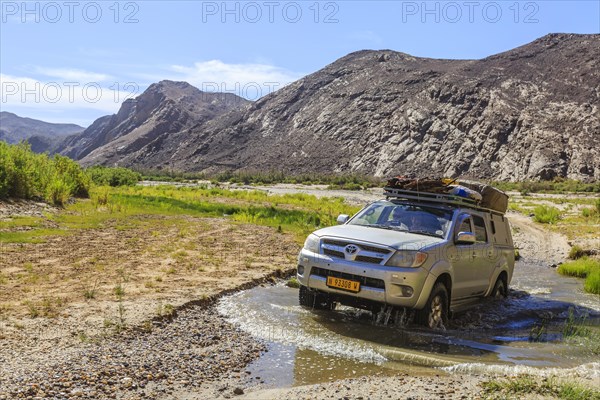 Off-road vehicle crosses Hoarusib River