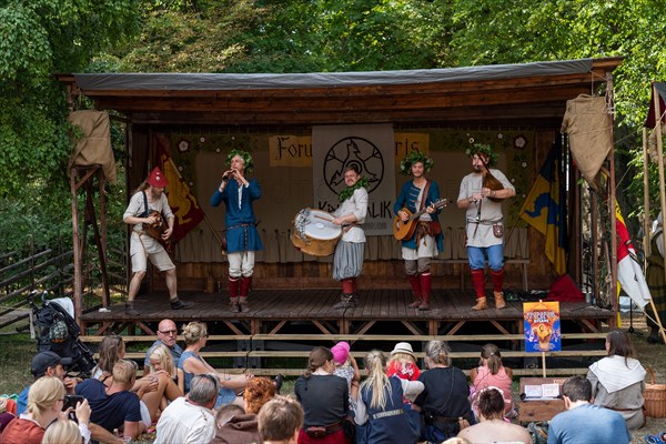 Musician in medieval traditional costumes on stage