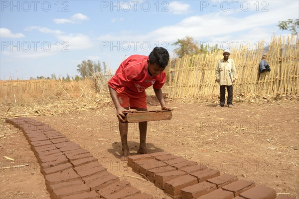 Teenager manufacturing bricks