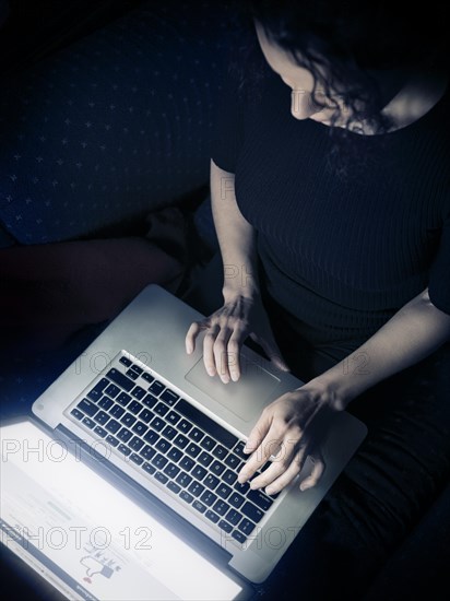 Woman using a laptop computer at home