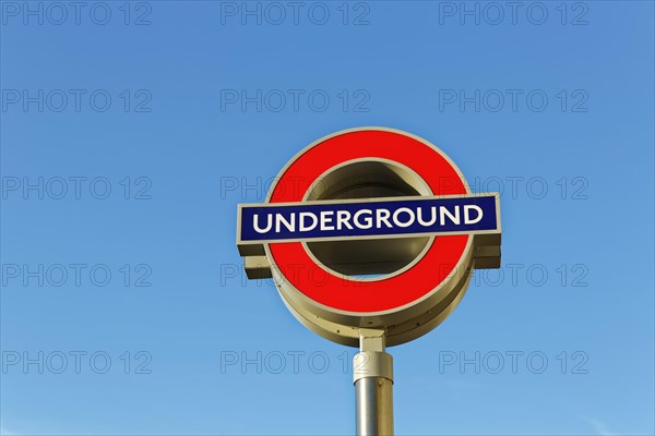 Underground signboard against blue sky