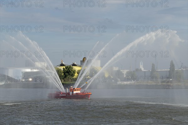 Fire-fighting boat with water fountains at the St. Pauli Piers