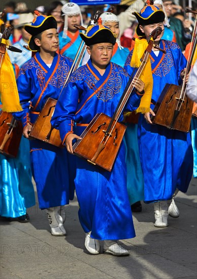 Youth in traditional Deel clothes and horse-head fiddle