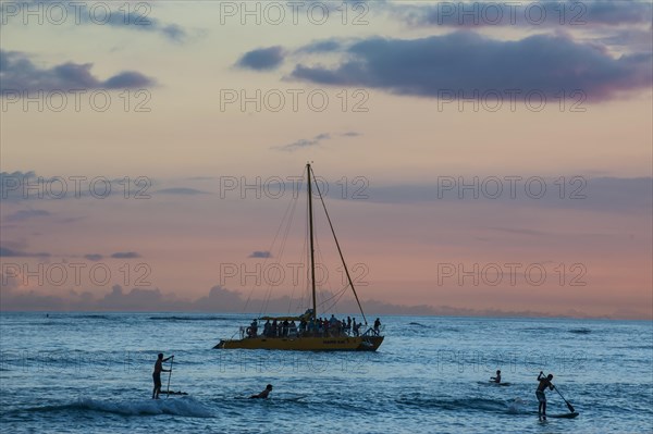 Evening light over sailing boat at Waikiki Beach