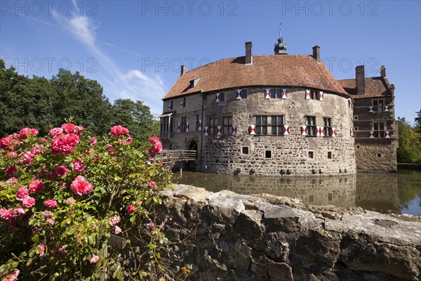 Vischering Castle with roses and moat