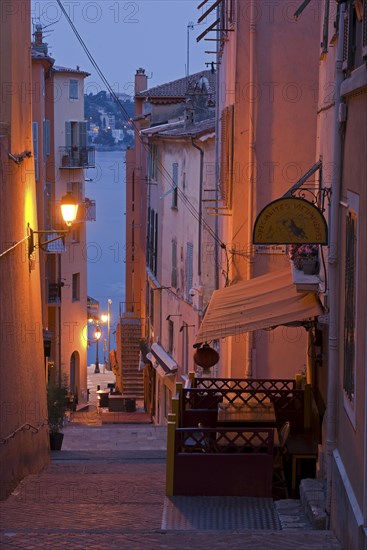 Steep narrow alley illuminated