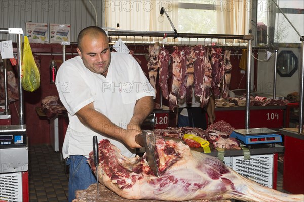 Butcher cutting meat