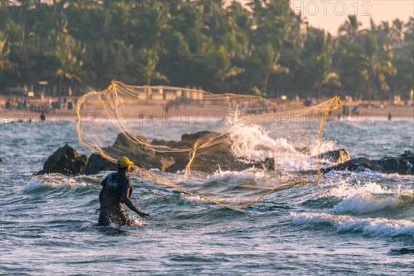 Local fisherman casts fishing net