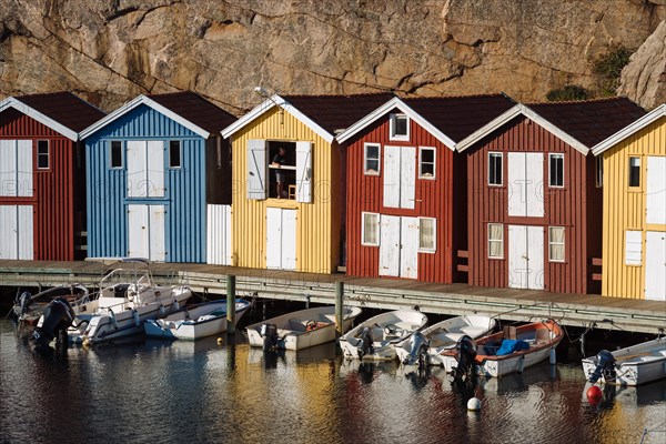 Boats and colourful boathouses in the harbour of Smogen