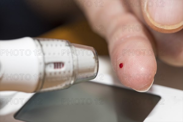 Diabetics taking a blood glucose test