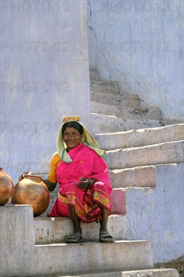 Native woman with water jugs