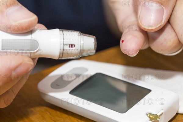 Diabetics taking a blood glucose test