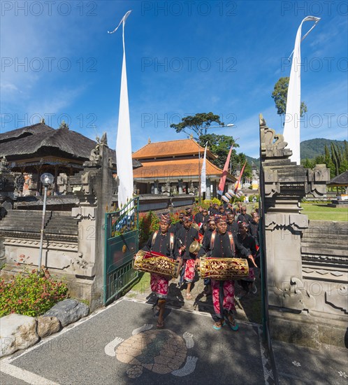 Procession of devout Buddhists at water temple Pura Ulun Danu Bratan water temple