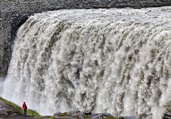 Person at the waterfall Dettifoss