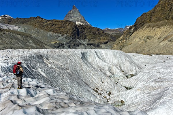 Mountaineer standing at an ice circle on the Gornergletscher