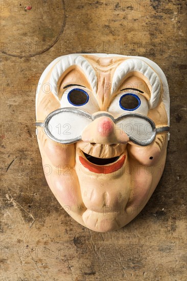 Painted wooden mask on a workbench