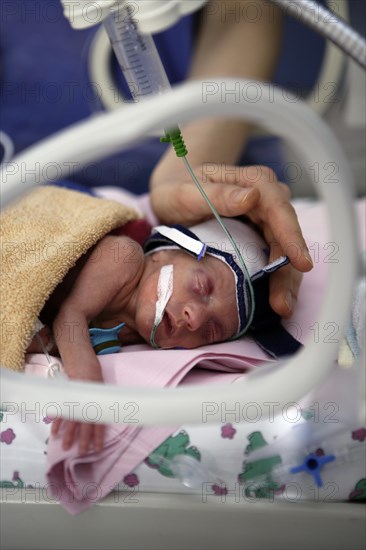 Incubator with newborn baby