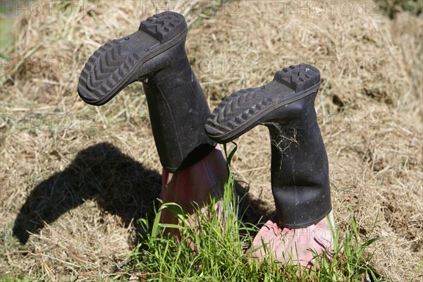 Wellington boots stuck in grass