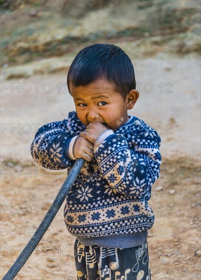 Little boy blowing into hose