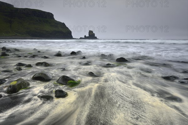 Stones in the sand on the beach of Talisker Bay